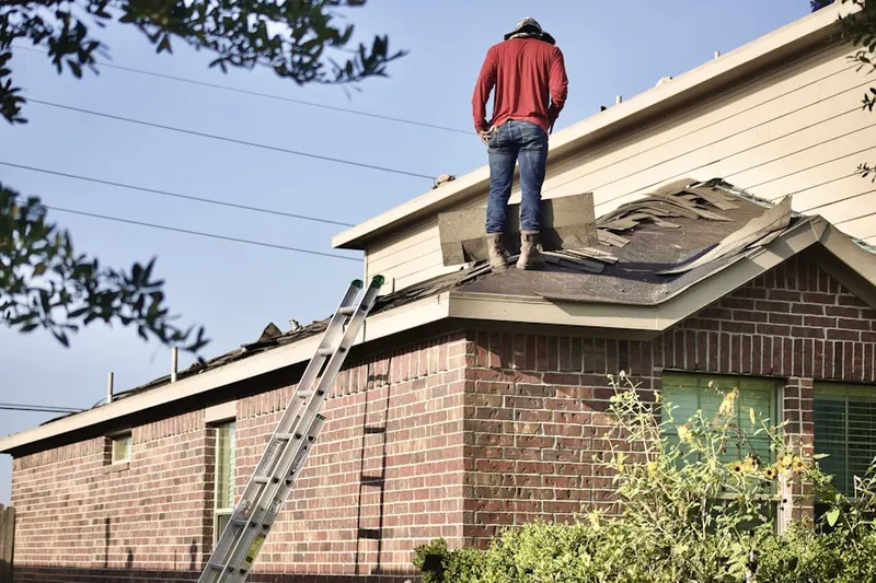 Professional roofer working on a residential roof in Rocky Ridge